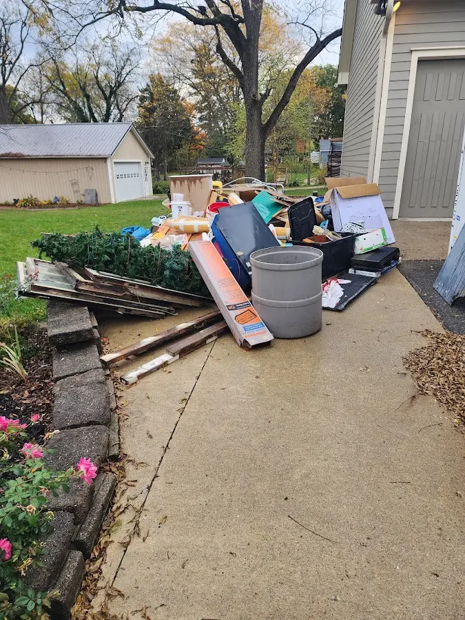 Dumpster being loaded with debris for Estate Cleanout Dumpster Rental in Plainville